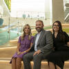 Chris Barnett with two of his daughters, smiling and sitting on steps