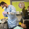 A clinic dentist and a young patient 